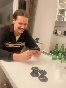 Man playing bees with a couple of beer bottles on the side