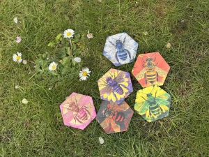 6 Bee tiles on the grass