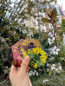 Hand holding three bee tiles